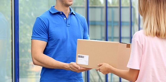 stock-photo-woman-receiving-parcel-from-delivery-service-courier-outdoors-1240823413